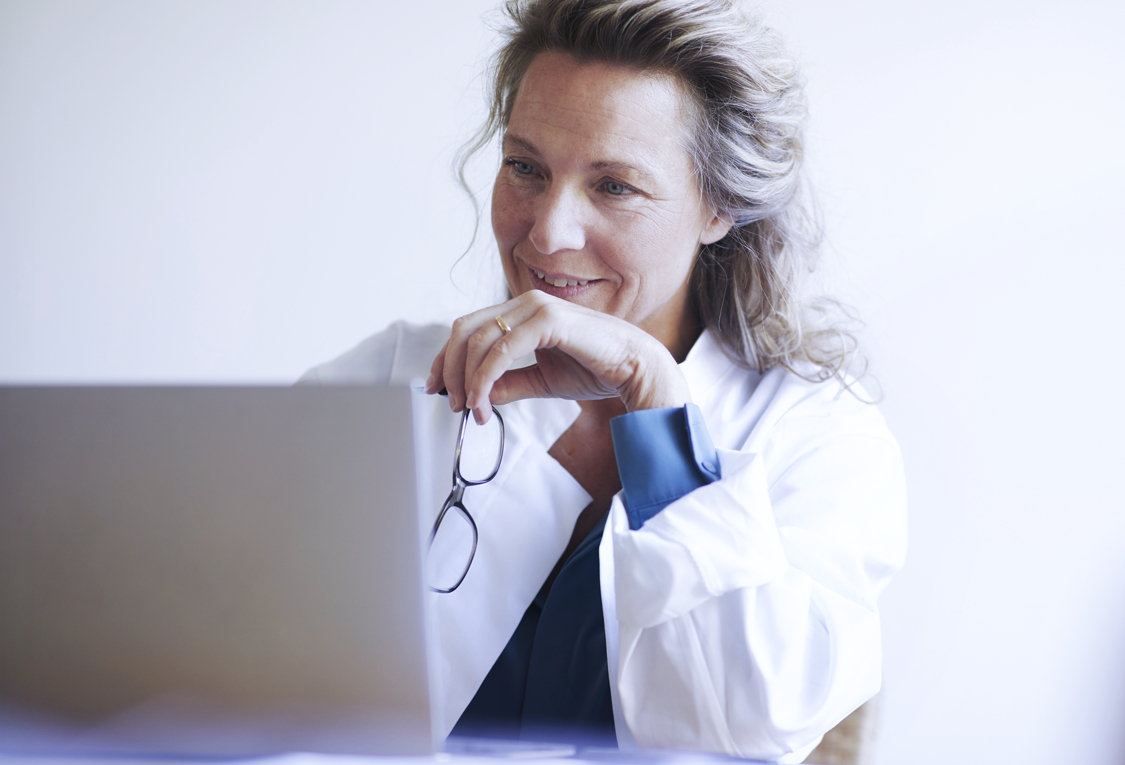 Female doc at computer_GettyImages-1224302214_RGB_flipped
